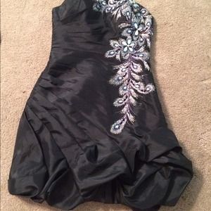 Black dress with a gold feather pattern.