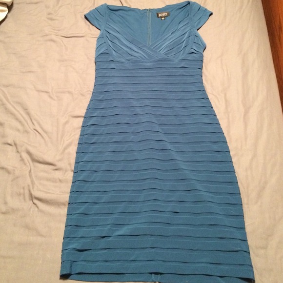 Dark turquoise curve hugging dress.