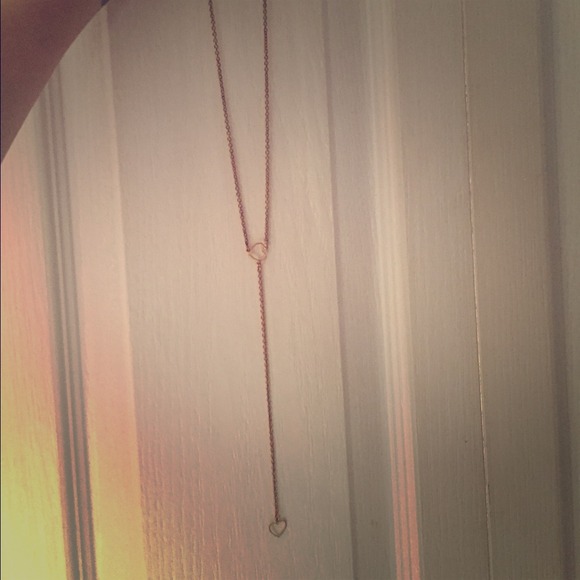Gold heart necklace reaches waist
