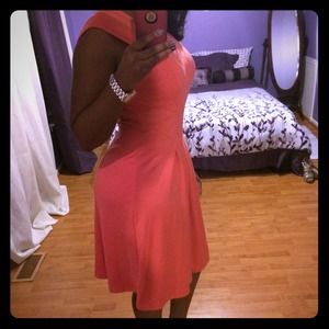 Orange knee length dress.