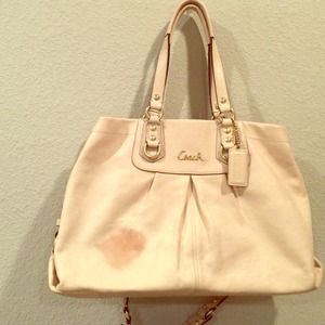 Cream coach handbag with unfortunate stain