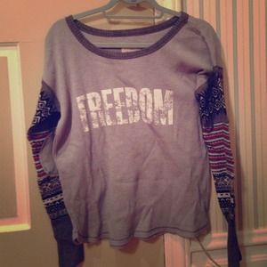 Grey shirt that says "freedom"