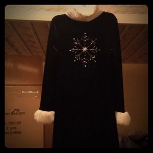 This is a black dress with white fur cuffs