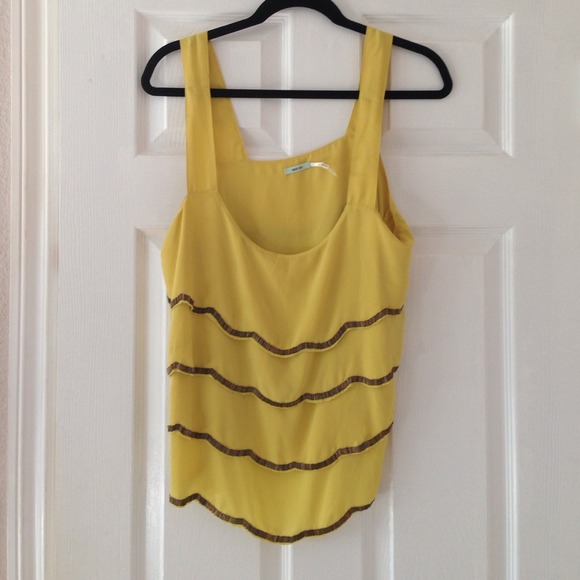 Yellow dressy tank with metal detailing.