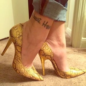 Yellow snakeskin pumps with gold heels