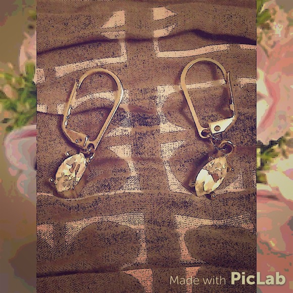 Oval shaped, silver, Diamond, lever back earrings.