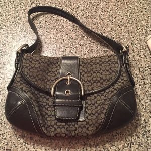 Medium sized black and white coach bag