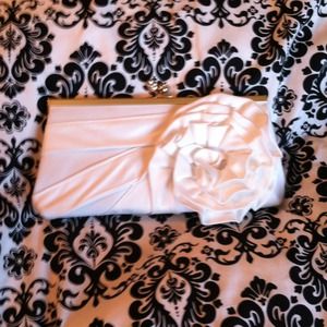 White satin clutch with flower embellishment