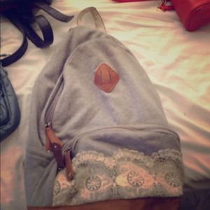 Grey backpack with lace on it