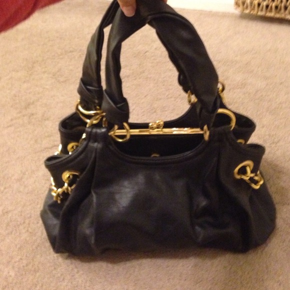 Black handbag w/ two coach wristlets