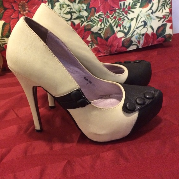 Black and white platform pumps w/ button detail.