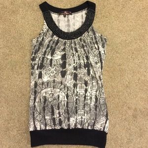 Sleeveless M top beaded neck front fitted waist.