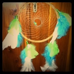 A lime green, turquise, and white Dream Catcher.