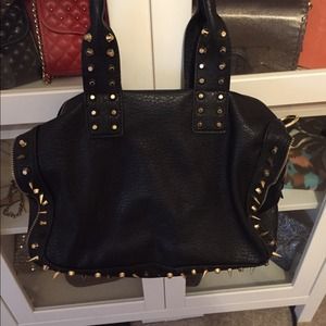 Black purse with gold hardware, studs and spikes