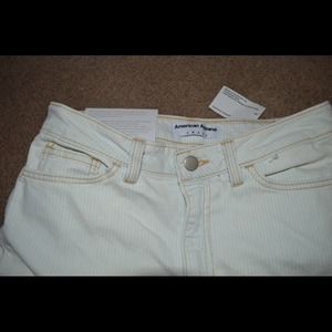 Denim and white pinstripe jeans with zip up ankles