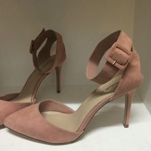 Pale pink pumps with ankle strap.