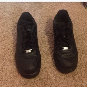 Black Air Force One sneakers.