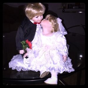 Kissing bride and groom porcelain dolls