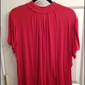 Orange/salmon colored top with small peephole back