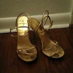 Gold strappy heels.