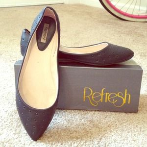 Black pointy-toe flats with studs