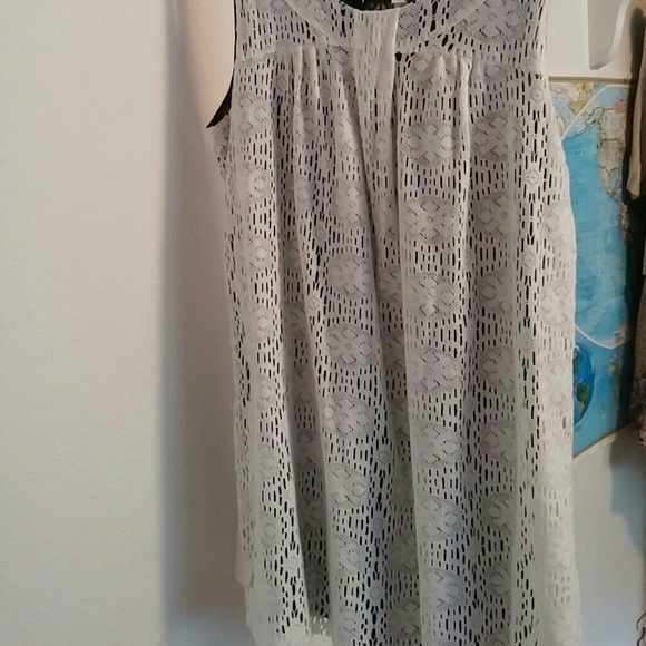 Sleeveless white lace mini dress