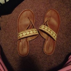 Brown and yellow american eagle flip flops