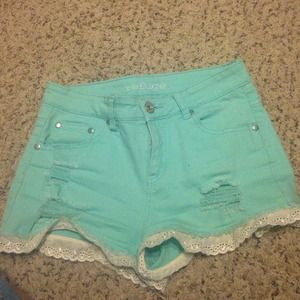 High waisted turquoise (?) shorts