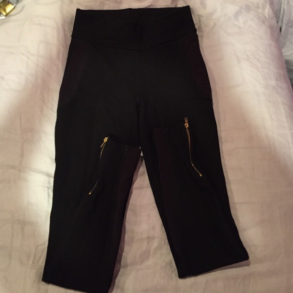 Black leggings with gold zip on bottom