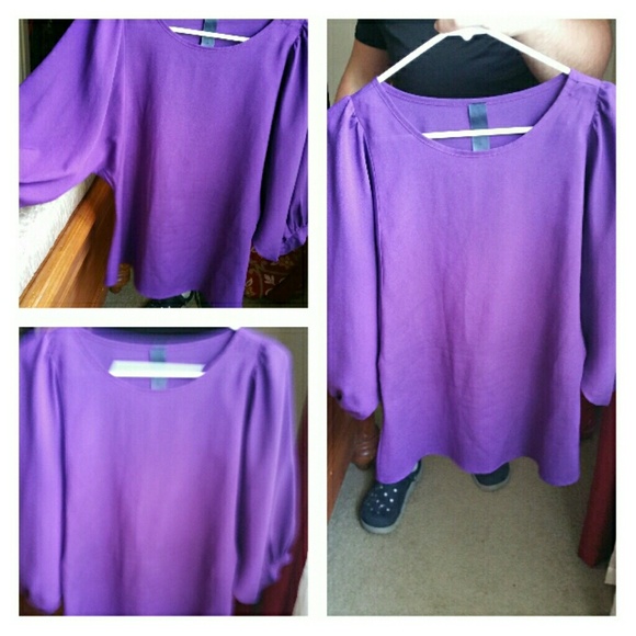 Purple blouse, baggy sleeves.