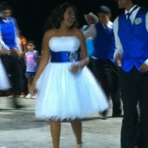 White dress with blue sash modeled