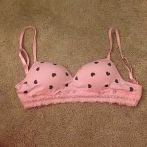 Pink bra with black hearts, lined with lace.