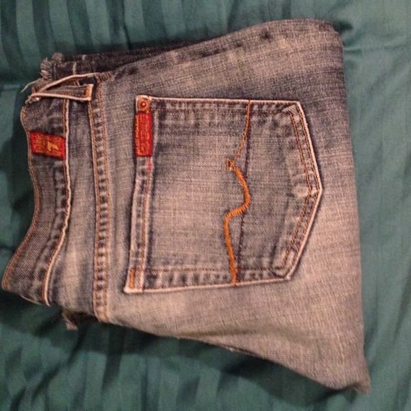 Flared jeans with faded wash.