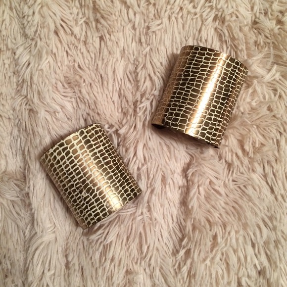 Gold textured arm cuffs.