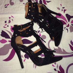 Black suede heels with gold accents