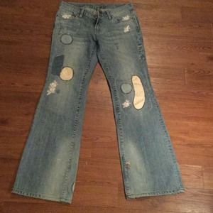 Distressed patched denim jeans