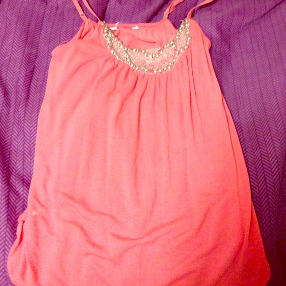 a badazelled peach color tank top