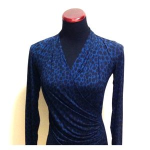 Blue/green blouse. Offers welcome