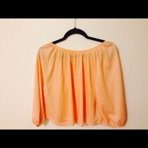 Peach blouse with bows on the back.