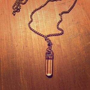 Long gold necklace with stone