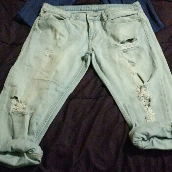 Cropped, ripped, light wash jeans.