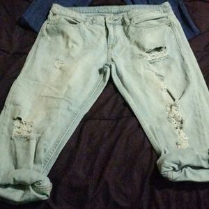 Cropped, ripped, light wash jeans.