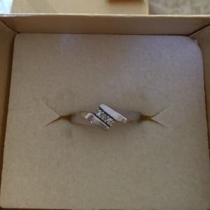 10k white gold ring with 3 small diamonds.