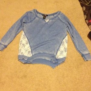 A light blue top with lace on both sides