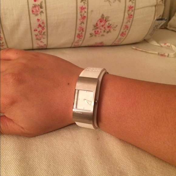 Fossil watch with white leather straps.