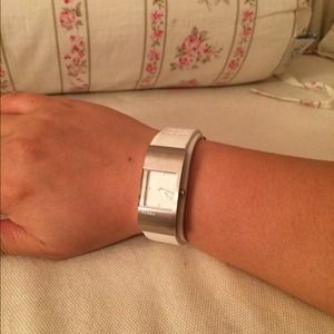 Fossil watch with white leather straps.