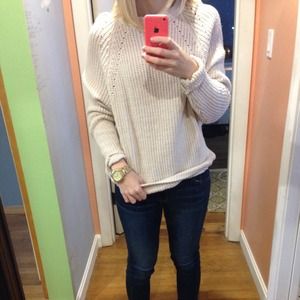 An oversized knitted cream sweater