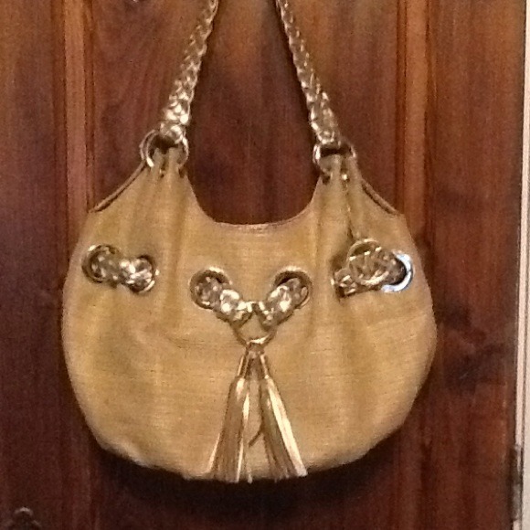 Micheal Korrs gold purse with tassel accent tie