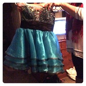 Semi-formal, short teal and sequined black dress.