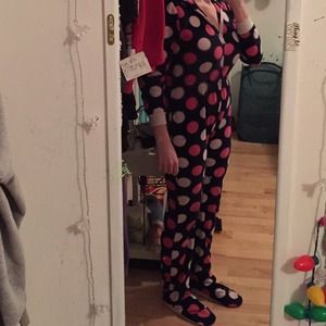 Black pink and white polka dotted footie pajamas